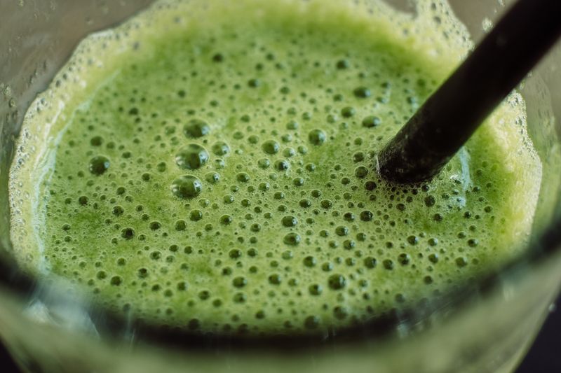 Fresh pressed green juice with cucumber and apple